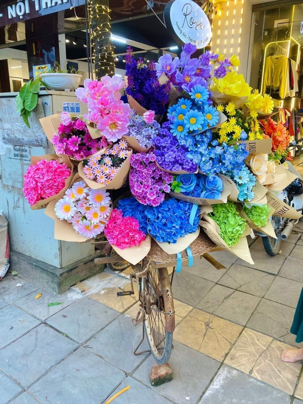 Young people in trend of check-in with flower bike on the streets