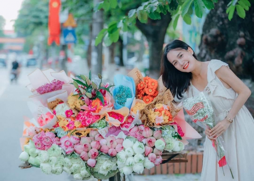 Young people in trend of check-in with flower bike on the streets